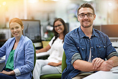 Buy stock photo Cropped portrait of three colleagues sitting in the office