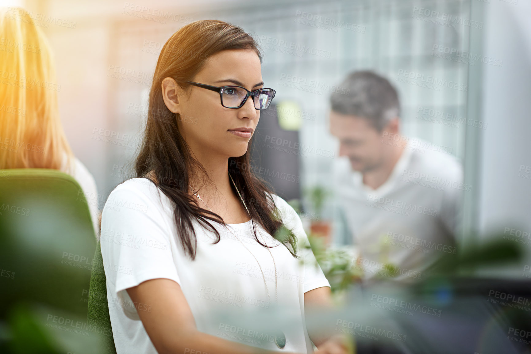 Buy stock photo Cropped shot of a young businesswoman working at her desk