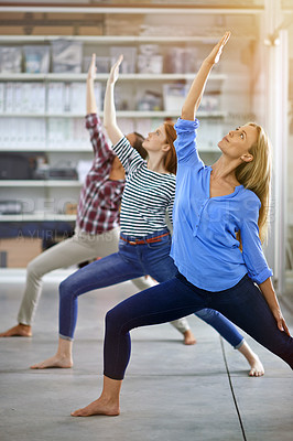 Buy stock photo Full length shot of three businesswomen doing yoga in the office