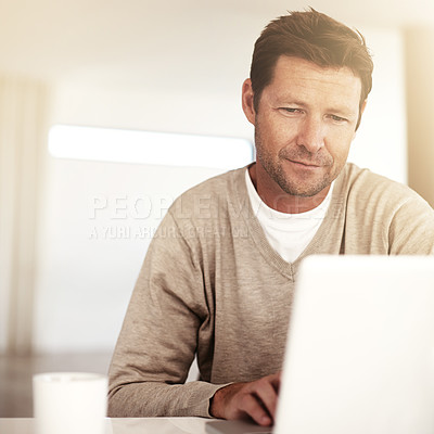 Buy stock photo Cropped shot of a man using his laptop at home