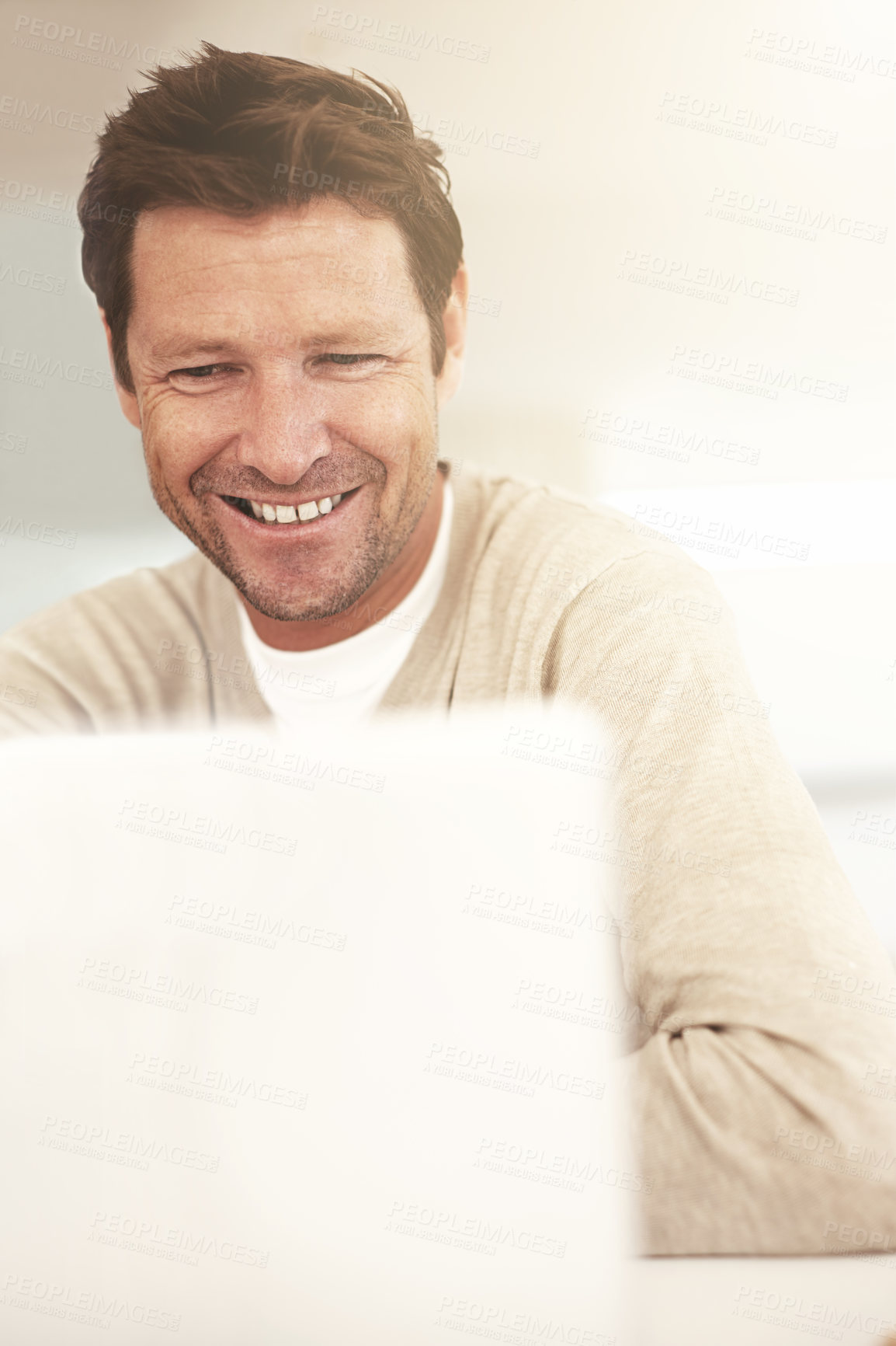 Buy stock photo Cropped shot of a man using his laptop at home