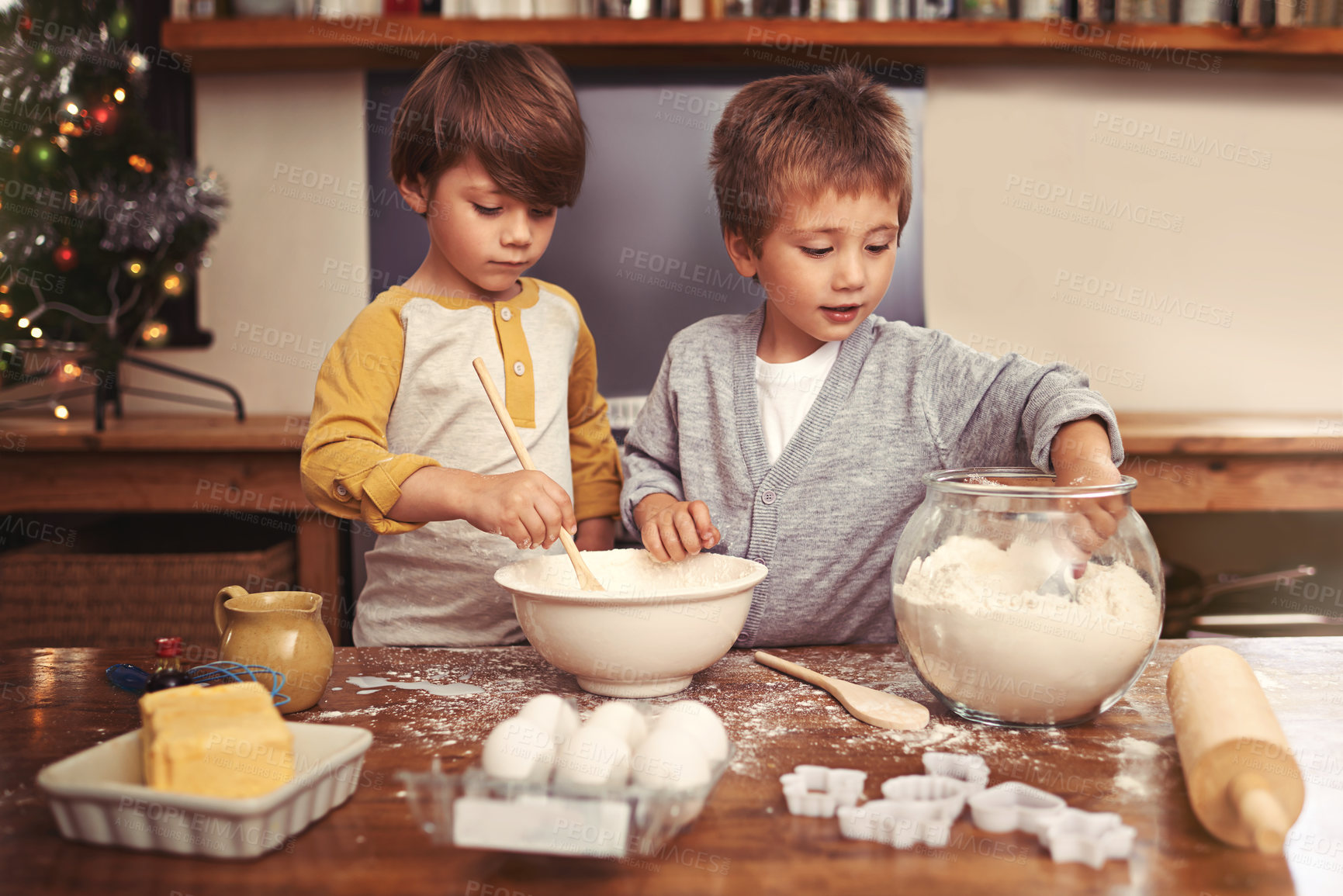 Buy stock photo Kids, baking and playing in kitchen with flour, home and bonding with ingredients for dessert cake. Children, mixing and bowl for cookies on counter, eggs and boys learning of pastry recipe by butter