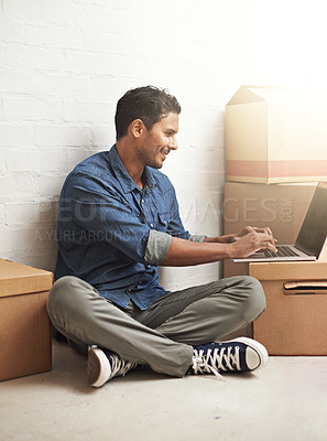 Buy stock photo Man, boxes and laptop working in new home, house and residence for moving, relocating or buying property. Male person, real estate or mortgage for homeowner with computer, communication or technology