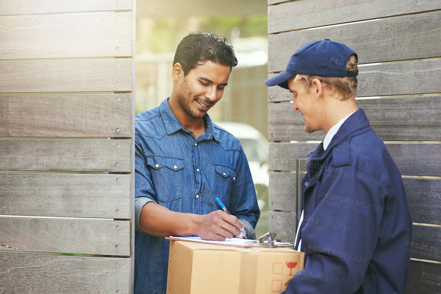 Buy stock photo Logistics, customer sign off package from delivery man and crm outdoors at the gate. Ecommerce or courier service, online shopping or product and shipment or exchange between people with signature
