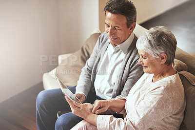 Buy stock photo Tablet, relax or old couple streaming movies or film on online subscription in retirement at home together. Love, internet or senior woman watching videos with a happy elderly man in living room sofa