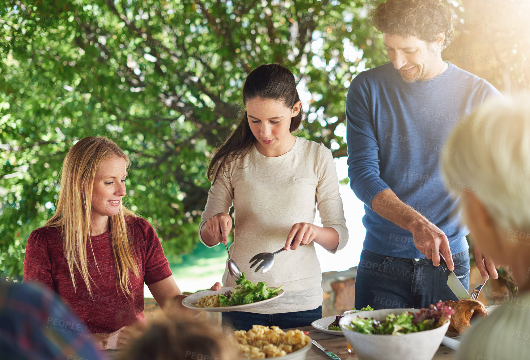 Buy stock photo Food, salad and share with family at lunch in nature for health, bonding and celebration. Vacation, social and event with parents and children eating together for dining, generations and wellness