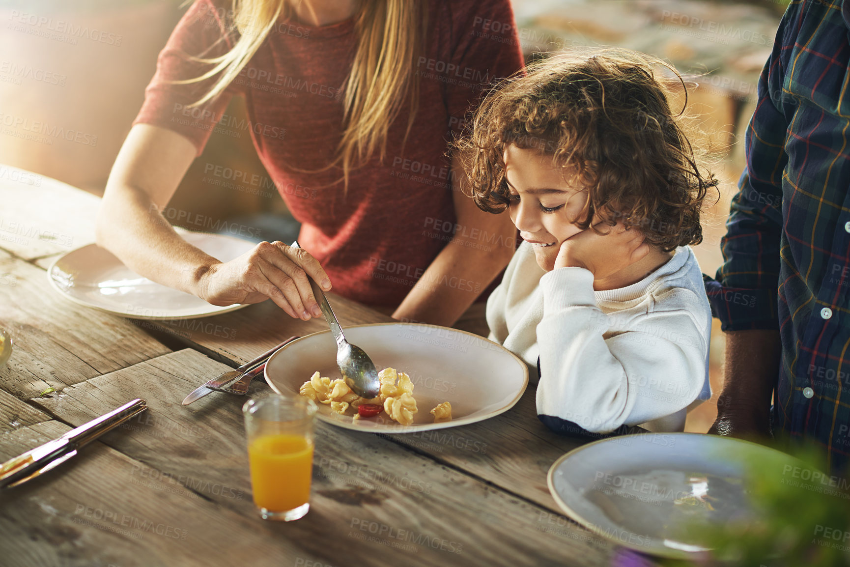 Buy stock photo High angle shot of a family to eating lunch together outdoors