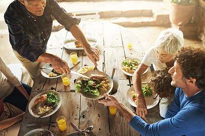 Buy stock photo Food, party and share with family at lunch from above for health, bonding and celebration. Vacation, social and event with parents and children eating together for dining, generations and wellness