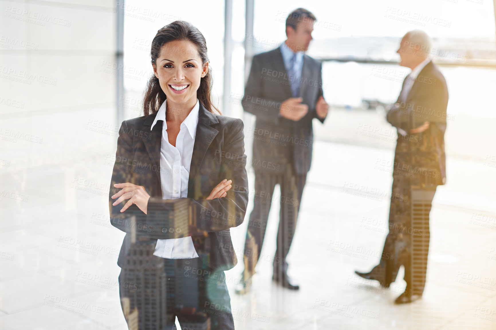 Buy stock photo Cropped portrait of a businesswoman standing a lobby with her colleagues in the background