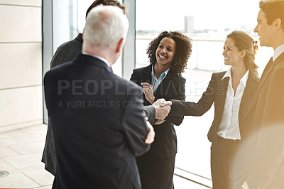 Buy stock photo Professional, handshake and group for negotiation at work with a smile to show support for collaboration. Business, people and agreement at the lobby for contract with success at a corporate office.