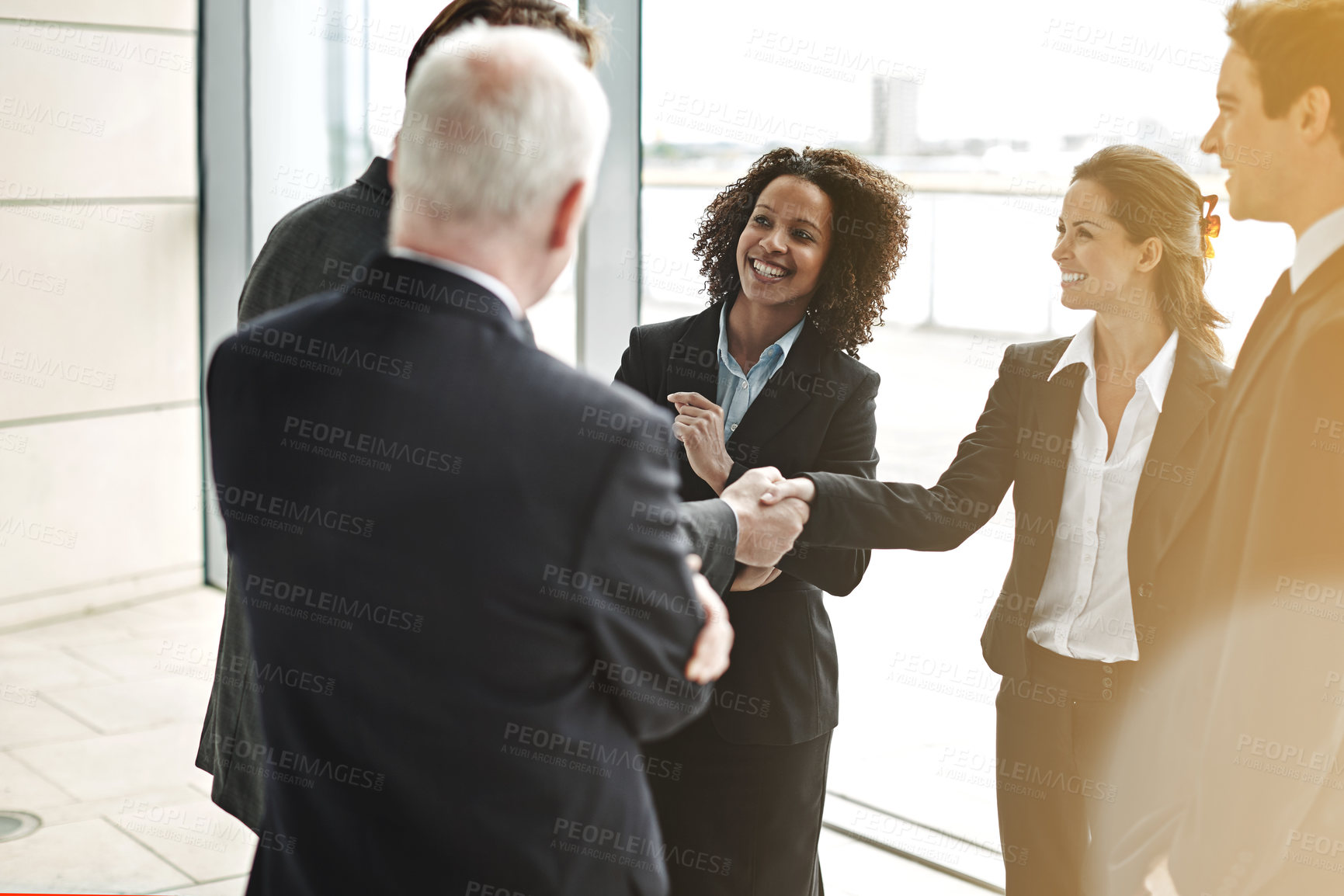 Buy stock photo Professional, handshake and group for negotiation at work with a smile to show support for collaboration. Business, people and agreement at the lobby for contract with success at a corporate office.