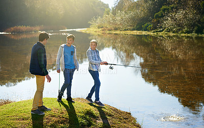 Buy stock photo Group of young boys and fishing, bonding together at a lake on summer holiday for fun adventure. Happy, friends and kids, in nature, play outside near water for hobby or recreation on vacation