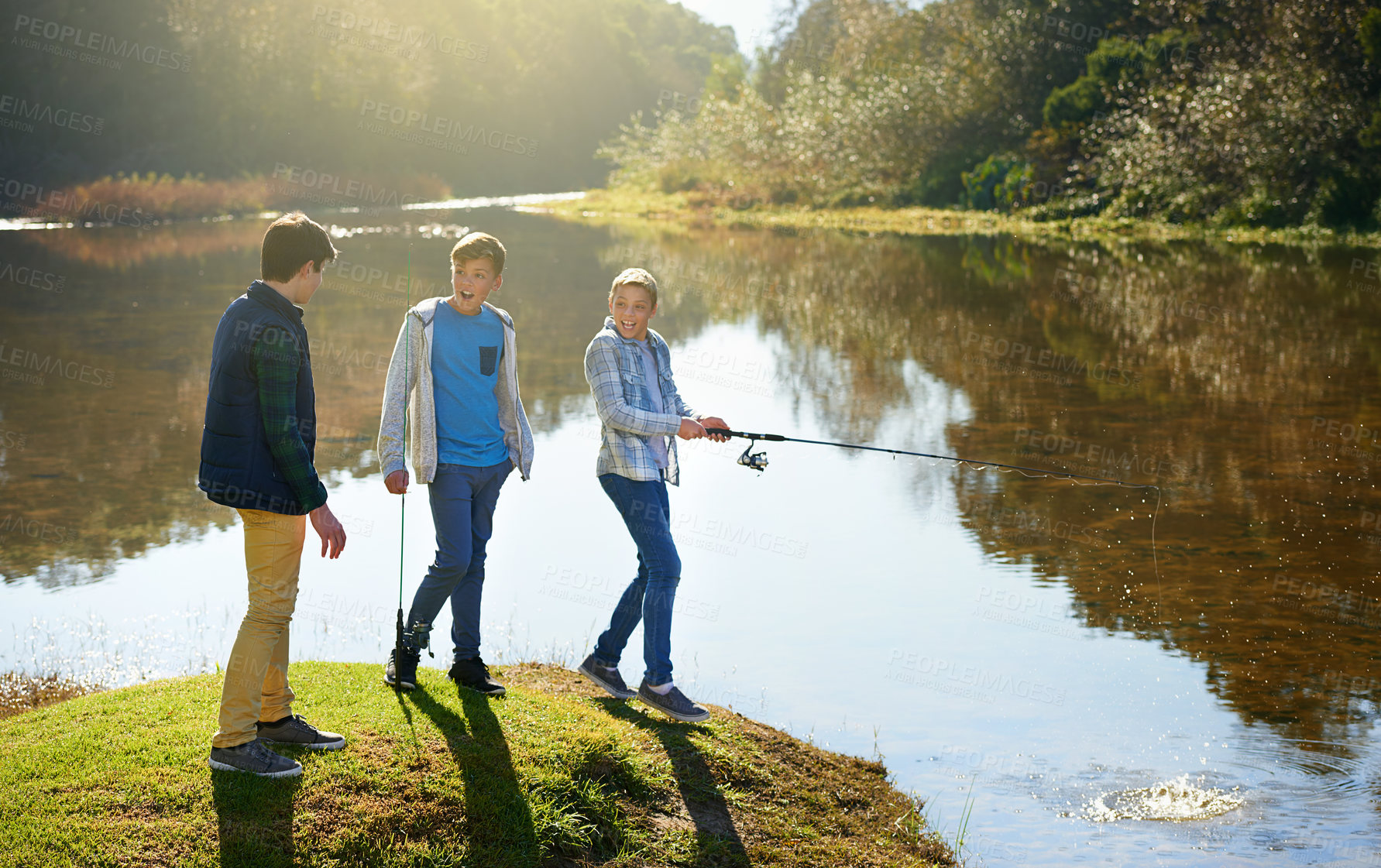 Buy stock photo Group of young boys and fishing, bonding together at a lake on summer holiday for fun adventure. Happy, friends and kids, in nature, play outside near water for hobby or recreation on vacation