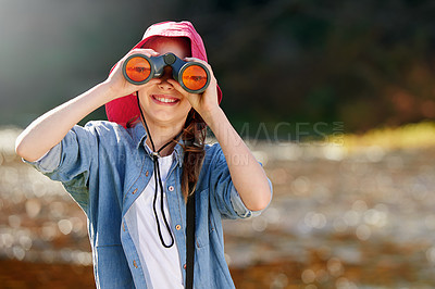 Buy stock photo Countryside, girl and binocular to watch in nature or observe animals, sightseeing or explore outdoors. Adventure, child and birdwatching for joy in farm or field, landscape and happy kid with smile