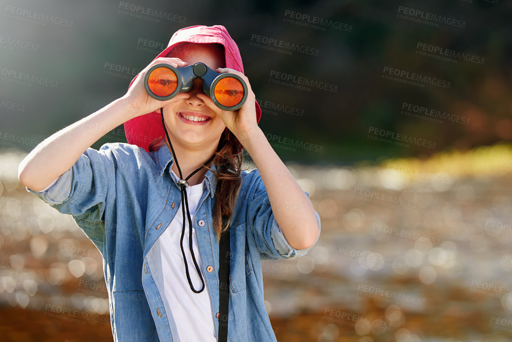 Buy stock photo Countryside, girl and binocular to watch in nature or observe animals, sightseeing or explore outdoors. Adventure, child and birdwatching for joy in farm or field, landscape and happy kid with smile