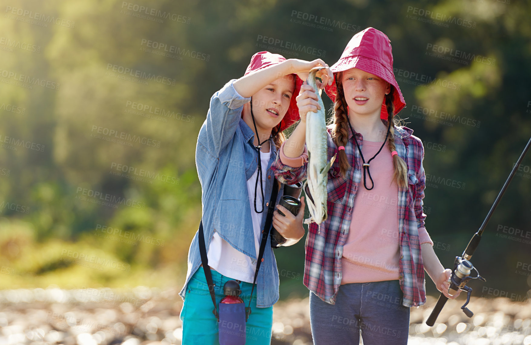Buy stock photo Countryside, children or caught fish in river on holiday break, vacation or adventure as hobby or activity. Sunshine, girls or siblings and fishing rod in water on weekend trip, outdoor and nature
