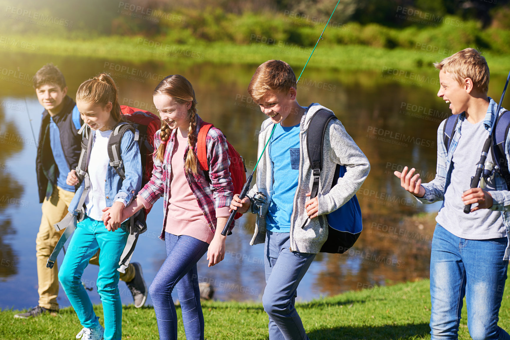 Buy stock photo Group of children and fishing outdoor at lake in nature for fun or hobby at summer camp. Happy, friends and walking to play with gear for water activity on holiday for outside recreation adventure