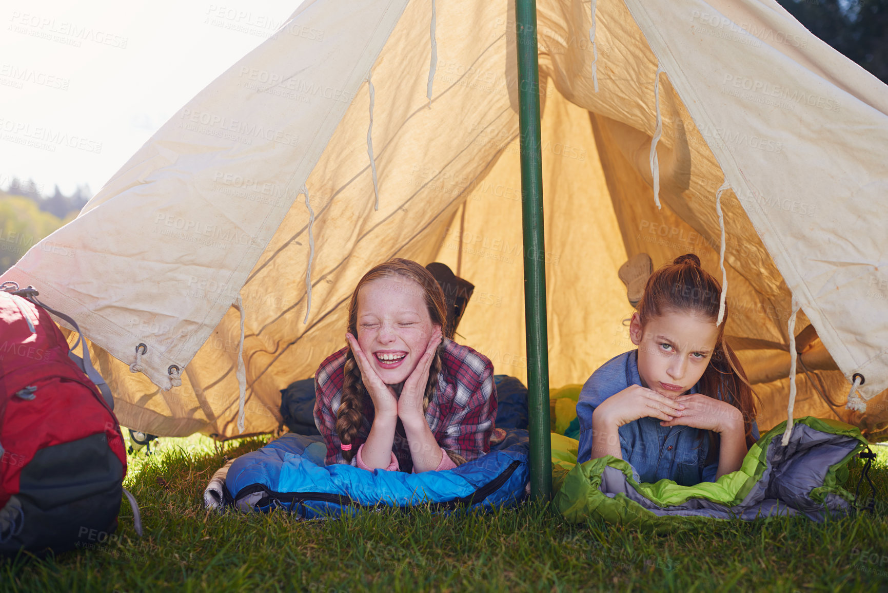 Buy stock photo Kids, gen z and camping in tent in nature for holiday, adventure and sleeping in woods for vacation. Portrait, happiness and friends on field trip for school, children and bootcamp for girls.