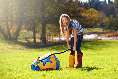 Buy stock photo Portrait of a teenage girl inflating an inflatable ball outdoors