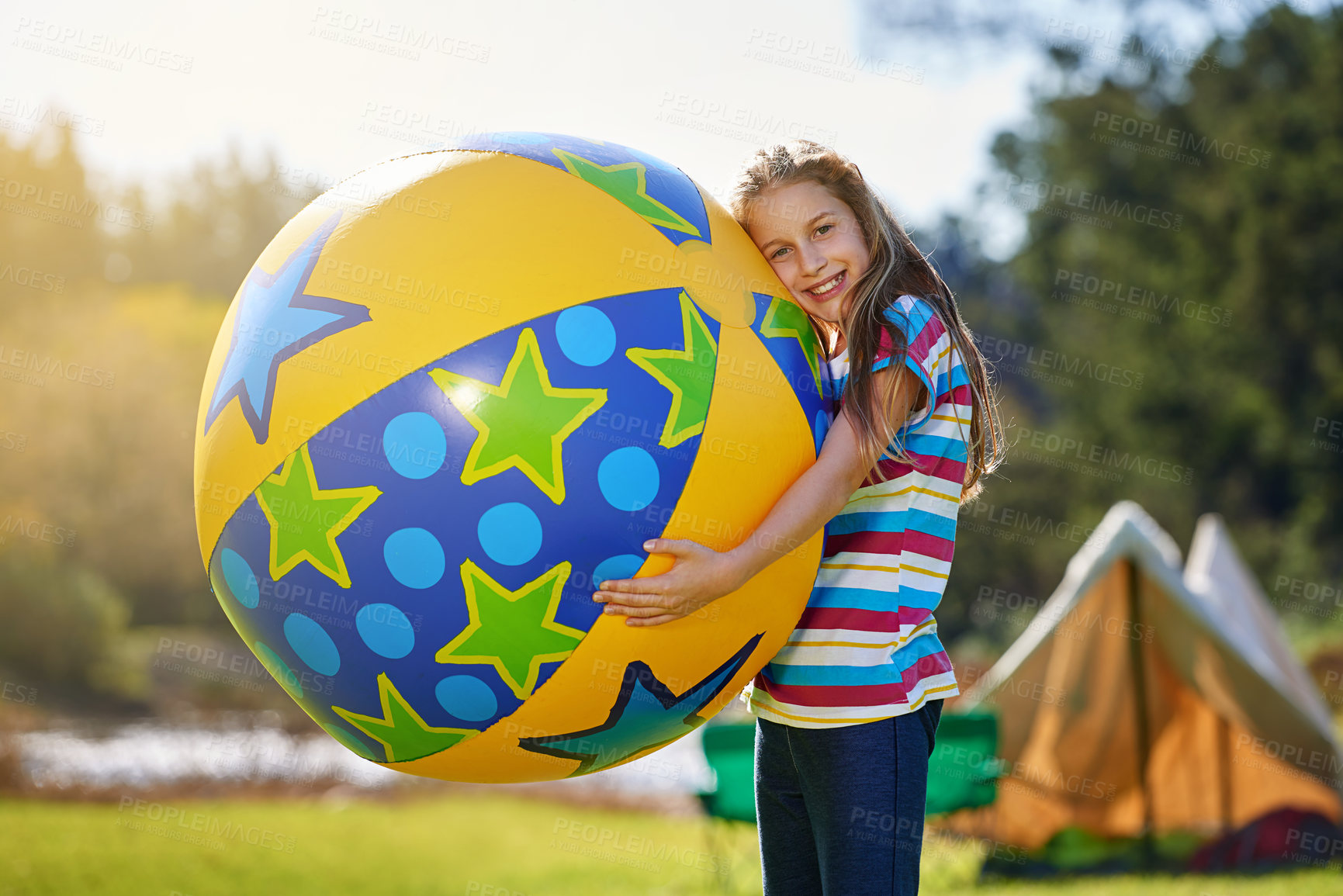 Buy stock photo Portrait of a teenage girl holding a huge inflatable ball outdoors