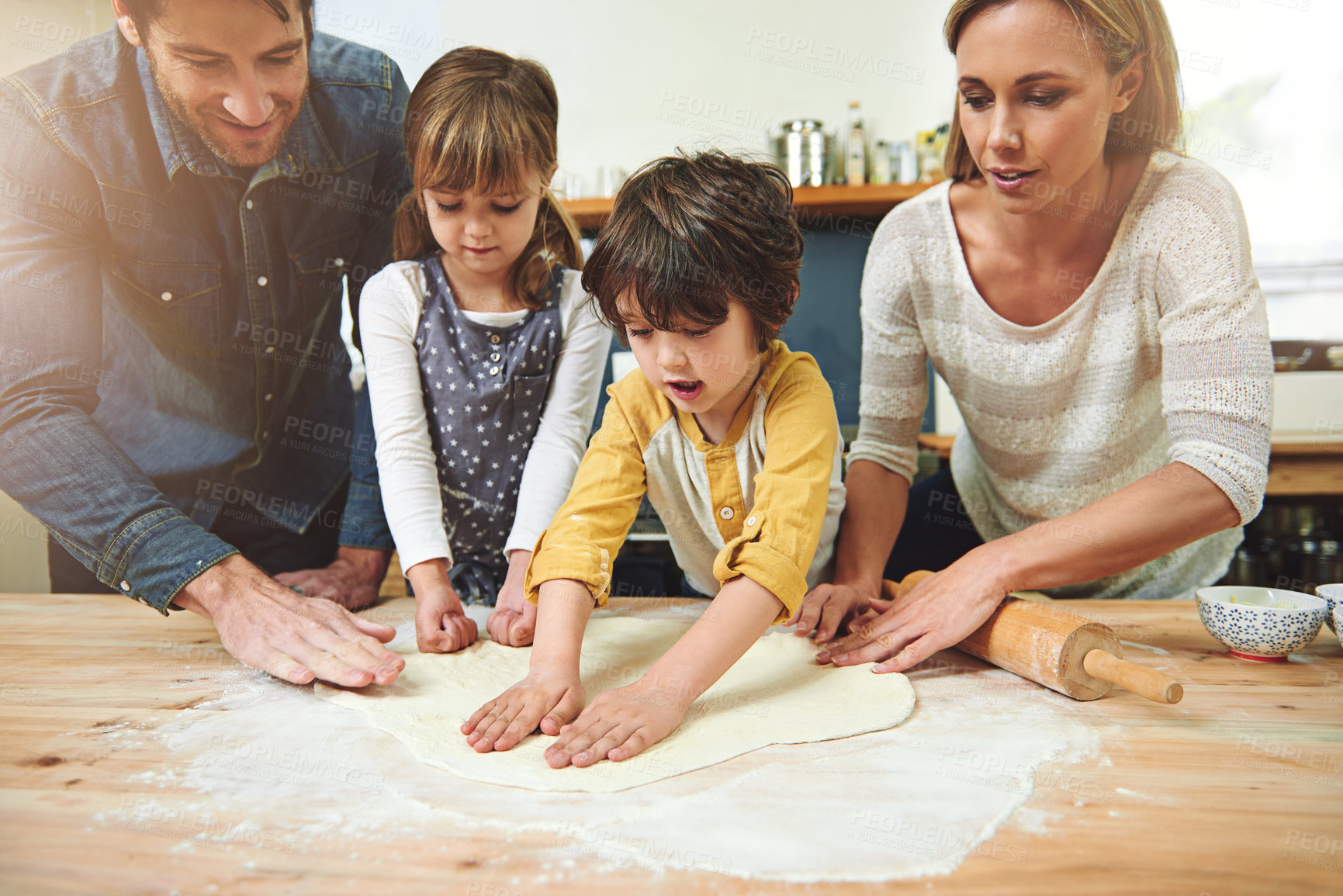 Buy stock photo Learning, smile and family baking food in kitchen together, bonding and happy in home. Pizza, mother and father with kids cooking, teaching and help parents with flour dough for preparation at table