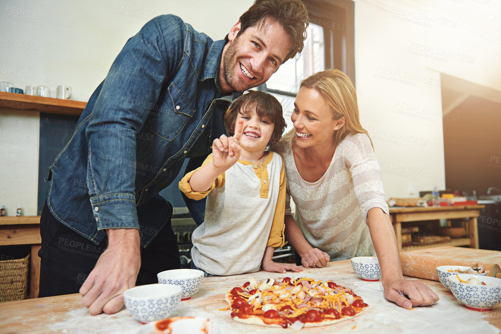 Buy stock photo Portrait, smile and family baking pizza in kitchen together, bonding and happy for learning in home. Face, mother and father with kid cooking with sauce, teaching and help parents with flour dough