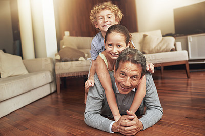 Buy stock photo Portrait, home and grandfather on the floor, grandkids and happiness with stack and holiday. Face, apartment and elderly man with grandchildren or bonding together with love and playing with siblings