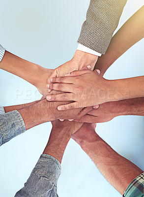Buy stock photo High angle shot of a group of coworkers with their hands in a huddle