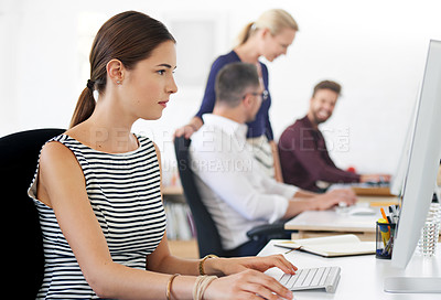 Buy stock photo Shot of a female designer working on her desktop computer