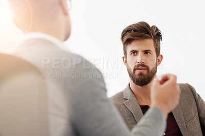 Buy stock photo Cropped shot of two businessmen having a discussion in the office