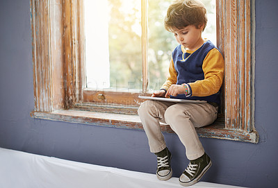Buy stock photo House, tablet and serious kid on internet, app or game on website for learning by windowsill. Technology, child and boy in home for education, scroll and watch cartoon online on digital electronics