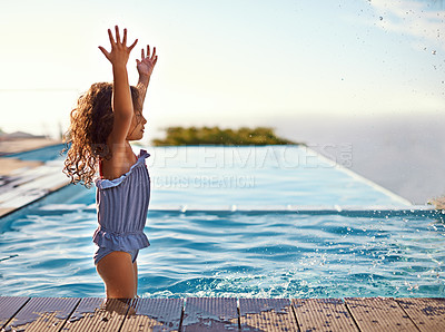 Buy stock photo Shot of a happy little girl playing in the pool