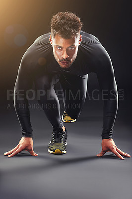 Buy stock photo Runner, portrait and man in studio with start, confidence and race challenge for health, wellness and power. Ready, running and strong athlete on black background for exercise, fitness or competition