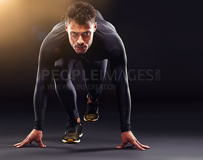 Buy stock photo Man, portrait and runner ready to start, race or intense sport focus in studio background. Serious, professional athlete and running, training or cardio motivation to win, workout or exercise mockup