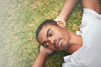 Buy stock photo Face, relax and thinking with black man in garden of summer home for peace, wellness or mindfulness. Nature, field and grass with thoughtful young person lying on ground from above for break or rest