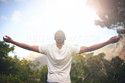 Buy stock photo Man, freedom and arms stretched, happiness and appreciate nature in sunlight. Black male person, outdoors and lensflare on vacation for adventure or optimist, grateful and wellness or blue sky