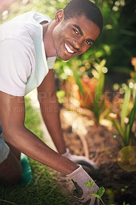 Buy stock photo Portrait, nature and planting flowers with black man in garden of home for summer landscaping. Face, smile and gardening with happy young person outdoor in backyard for growth or green cultivation