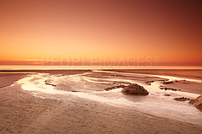 Buy stock photo A beautiful golden sunset over the sea on the west coast of Jutland in Loekken, Denmark wth copy space. Sun setting over the ocean horizon on an empty beach at dusk in the evening with copyspace