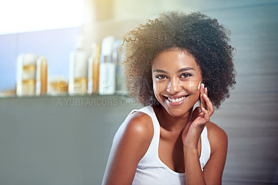 Buy stock photo African woman, portrait and facial cream with smile, wellness or afro in home bathroom for morning routine. Girl, person and serum with cosmetics, beauty and transformation with skincare in apartment