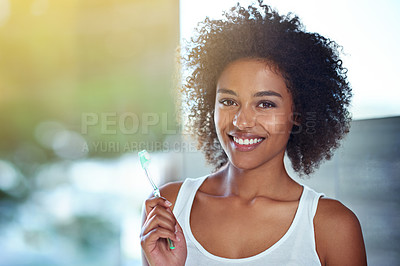 Buy stock photo Cropped portrait of a young woman brushing her teeth in the bathroom