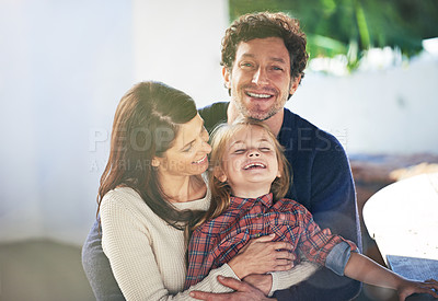 Buy stock photo Portrait of a happy family of three smiling while relaxing together