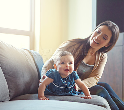 Buy stock photo Shot of a mother and her baby girl on the sofa at home