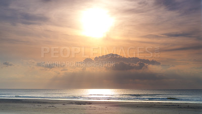 Buy stock photo Seascape and landscape of a golden sunset on the west coast of Jutland in Loekken, Denmark. Beautiful cloudscape on an empty beach at dusk. Clouds over the ocean and sea in the evening with copyspace