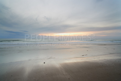 Buy stock photo Seascape and landscape of a blue sunset on the west coast of Jutland in Loekken, Denmark. Beautiful cloudscape on an empty beach at dusk. Clouds over the ocean and sea in the evening with copyspace