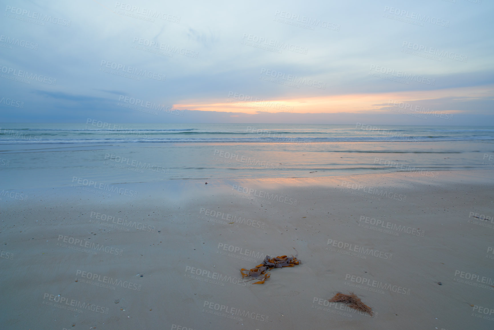 Buy stock photo Seascape and landscape of a blue sunset on the west coast of Jutland in Loekken, Denmark. Beautiful cloudscape on an empty beach at dusk. Clouds over the ocean and sea in the evening with copyspace 