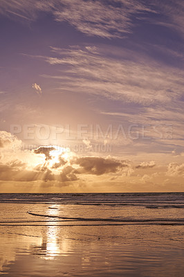 Buy stock photo Seascape of a beautiful sunset on the west coast of Jutland in Loekken, Denmark. Sun setting on the horizon on an empty beach at dusk over the ocean and sea at night with copyspace