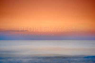 Buy stock photo Copyspace seascape of an orange sunset on the west coast of Jutland in Loekken, Denmark. Sun setting on the horizon on an empty beach at dusk over the ocean and sea at night. Sunrise in the morning