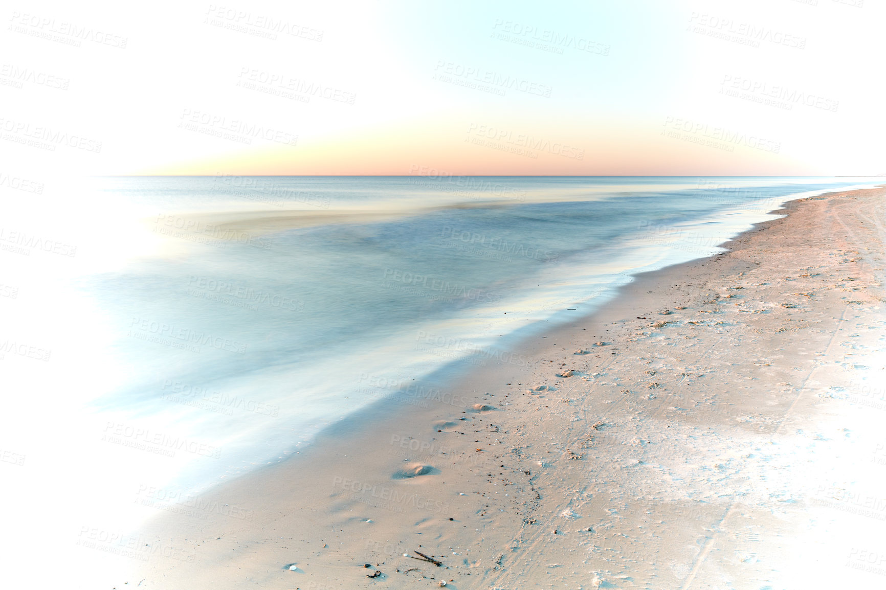 Buy stock photo Long exposure of waves washing on empty beach with copyspace at sunset with creative white vignette. Beautiful seascape and landscape at dusk on west coast of Jutland, Loekken, Denmark. Ocean and sea