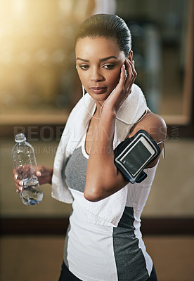 Buy stock photo Fitness, woman and music with water bottle to exercise or workout at gym. Female person, sport and thinking with audio technology, playlist and podcast for health or wellness with cardio training