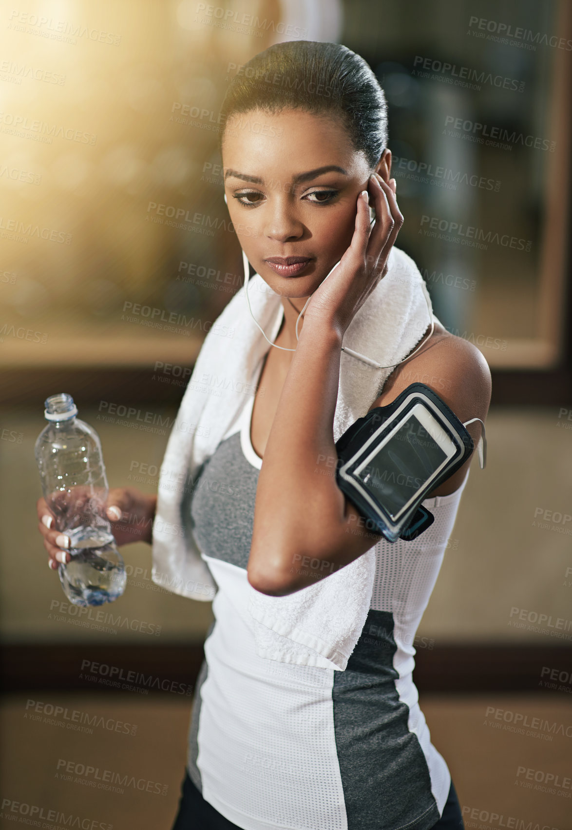 Buy stock photo Fitness, woman and music with water bottle to exercise or workout at gym. Female person, sport and thinking with audio technology, playlist and podcast for health or wellness with cardio training
